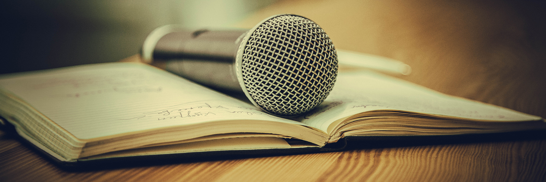 A microphone sits on top of an open book.