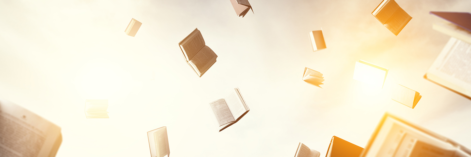 Open books flying around on a light background.